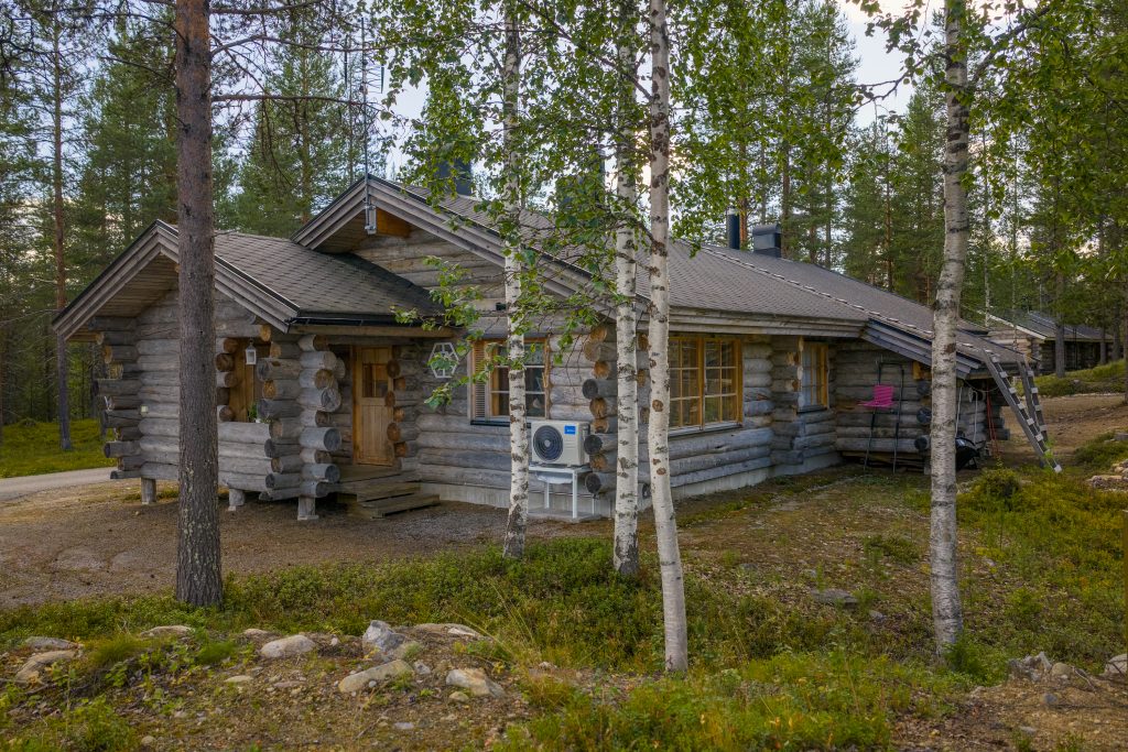 Puinen kelomökki puiden keskellä